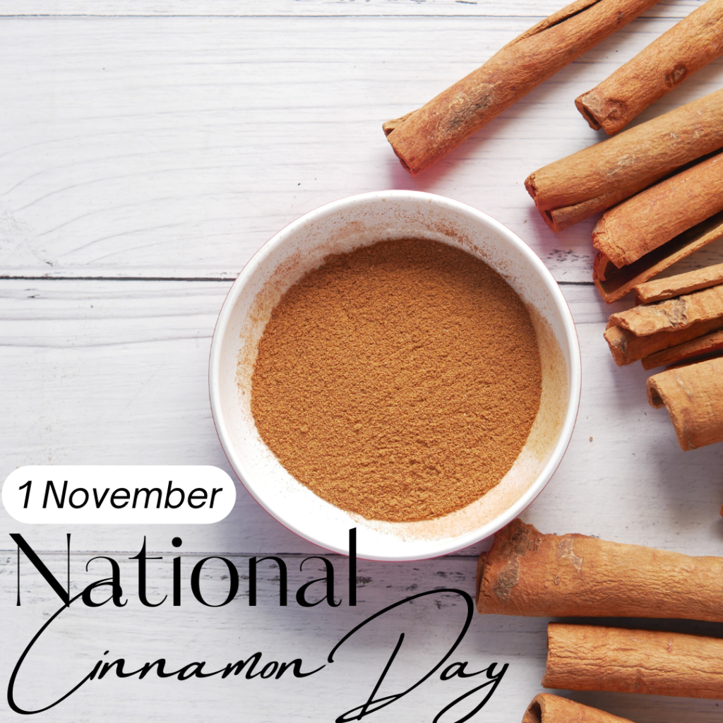 Happy National Cinnamon Day.  November 1st.  Ground cinnamon in bowl.  Cinnamon sticks.  White wood background.